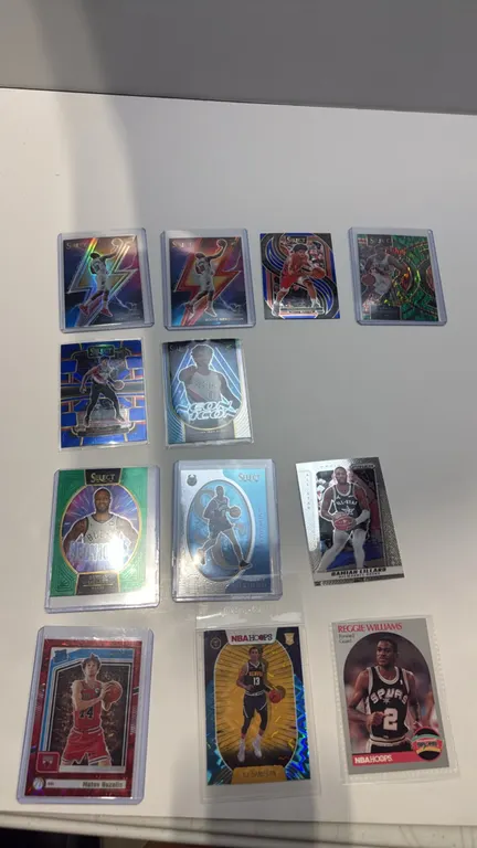 A Collection of (12) Assorted Basketball Trading Cards. (Panini/Donruss) Includes Panini Select Scoot Henderson rookie cards, Damian Lillard inserts,