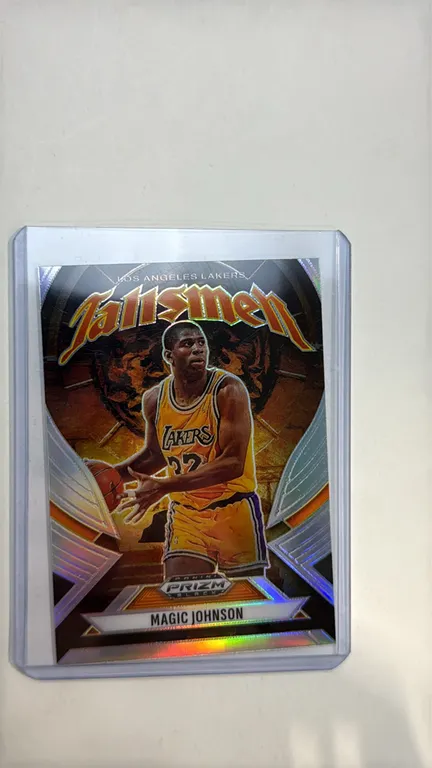 A 2024-25 Panini Prizm Black "Talismen" Magic Johnson Basketball Card. (Panini, 2024-25) An insert card No. 19 featuring Magic Johnson in his Los Ange
