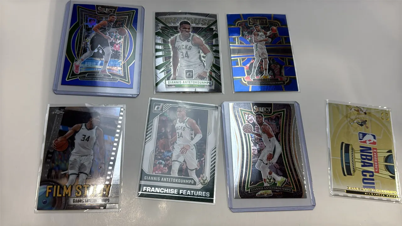A Collection of Giannis Antetokounmpo Basketball Trading Cards. (Panini/Topps, 2023-2025) A 7-card lot including Panini Select Mezzanine #326, Topps C