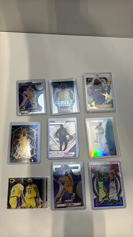 A Collection of LeBron James Basketball Cards. (Panini/Topps, 2020-2025) A collection of (9) modern trading cards featuring LeBron James with the Los