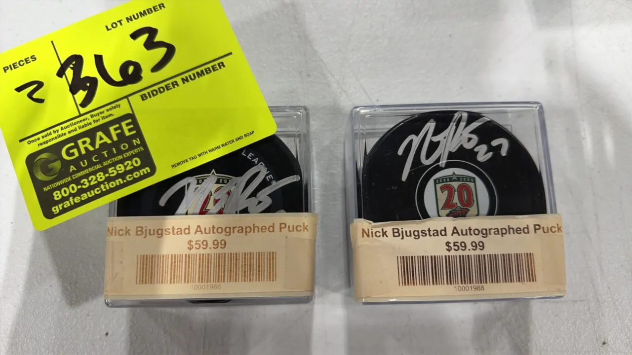 A Pair of Nick Bjugstad Autographed Minnesota Wild Hockey Pucks. (Minnesota Wild, 2020-2021) Each regulation puck features the franchise's 20th Annive