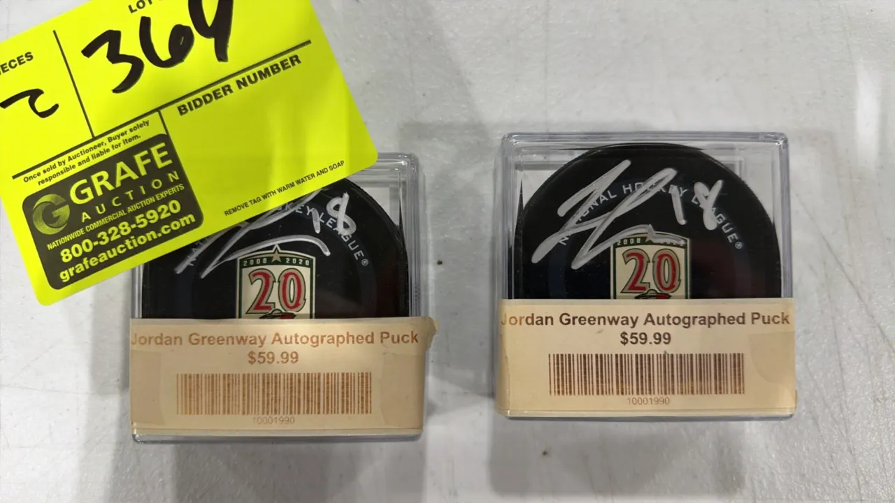 A Pair of Jordan Greenway Autographed Minnesota Wild Hockey Pucks. (Minnesota Wild, 2020) Commemorative pucks featuring the 2000-2020 20th Anniversary