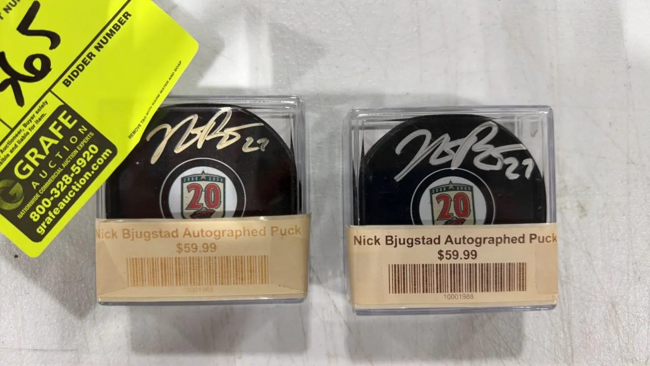 A Pair of Nick Bjugstad Autographed Minnesota Wild Hockey Pucks. (Minnesota Wild, 2020) Official hockey pucks featuring the Minnesota Wild 20th Annive