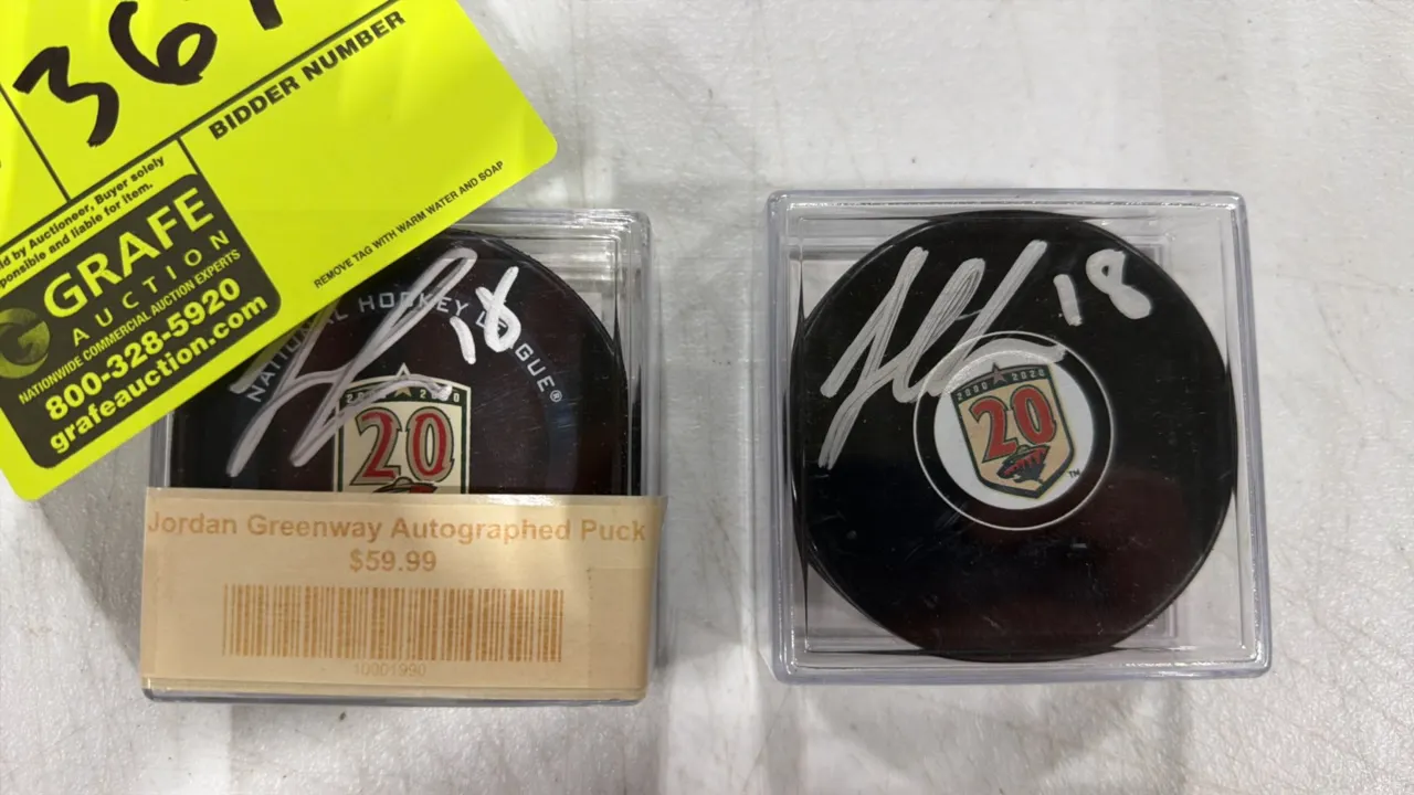 A Pair of Jordan Greenway Autographed Minnesota Wild Hockey Pucks. (Minnesota Wild/NHL, 2020) Official hockey pucks featuring the 2000-2020 20th Anniv