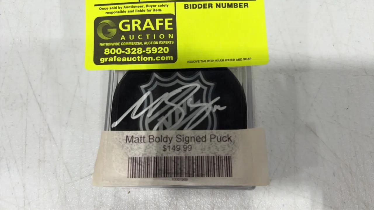 A Matt Boldy Autographed NHL Puck. (Fanatics Authentic) An official NHL licensed puck hand-signed by Matt Boldy in silver marker across the NHL shield
