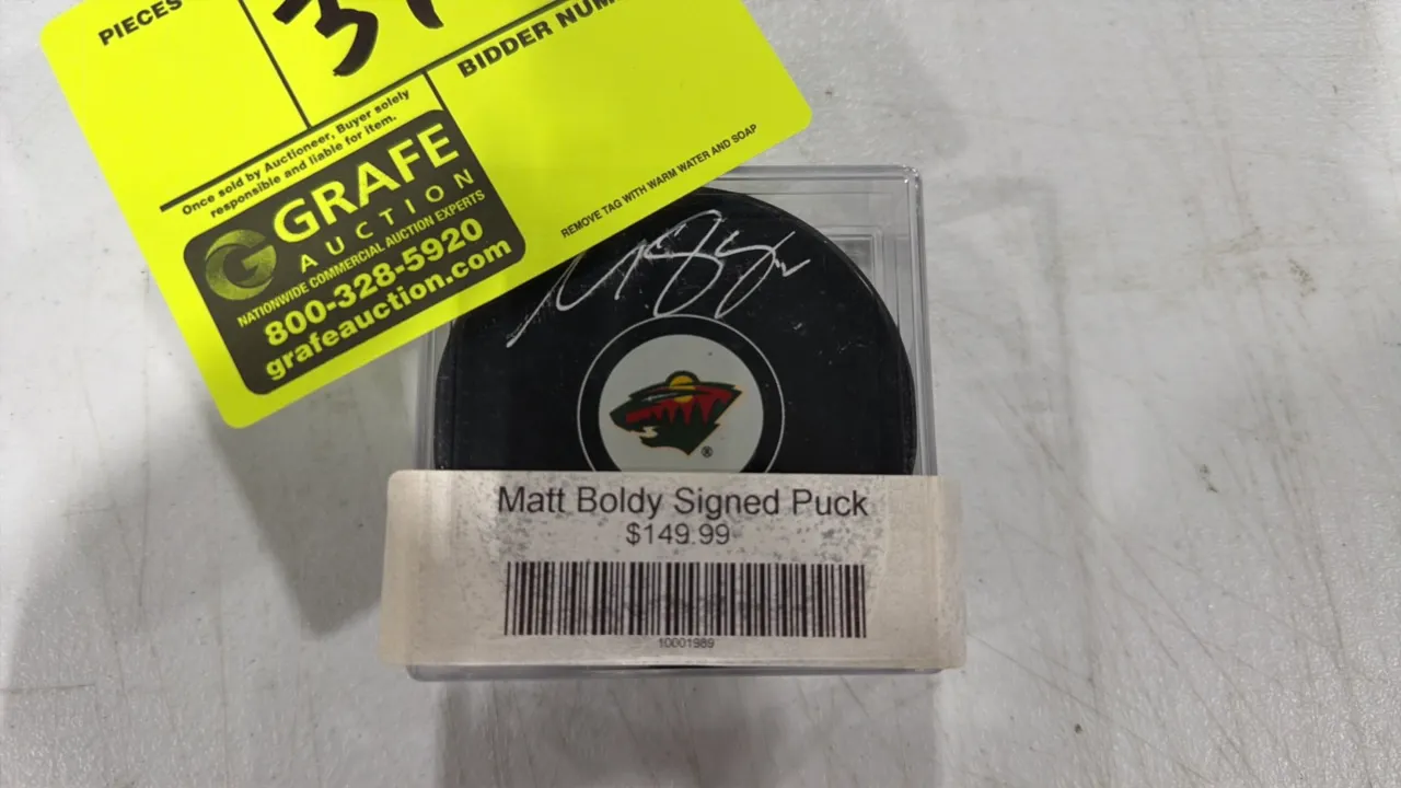 A Matt Boldy Autographed Minnesota Wild Hockey Puck. (Fanatics/NHL) An official NHL licensed hockey puck featuring the Minnesota Wild logo, hand-signe