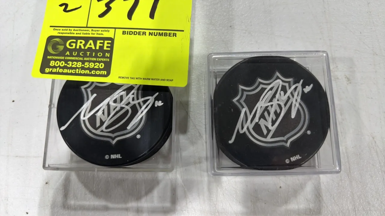 Matt Boldy autographed NHL hockey pucks. Features white ink signatures over the NHL shield logo on black pucks. Includes clear plastic display cases.