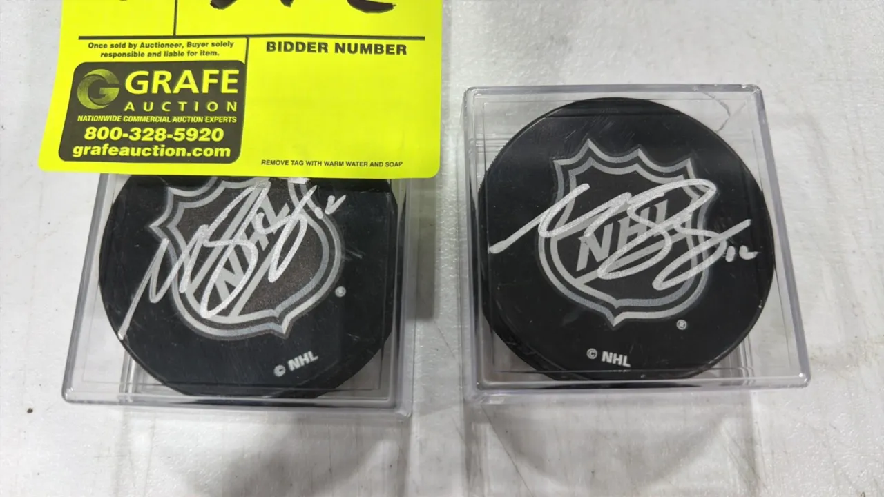 A Pair of Matt Boldy Autographed NHL Hockey Pucks. (NHL) Regulation hockey pucks hand-signed by Matt Boldy in silver-tone ink across the face. Each pu