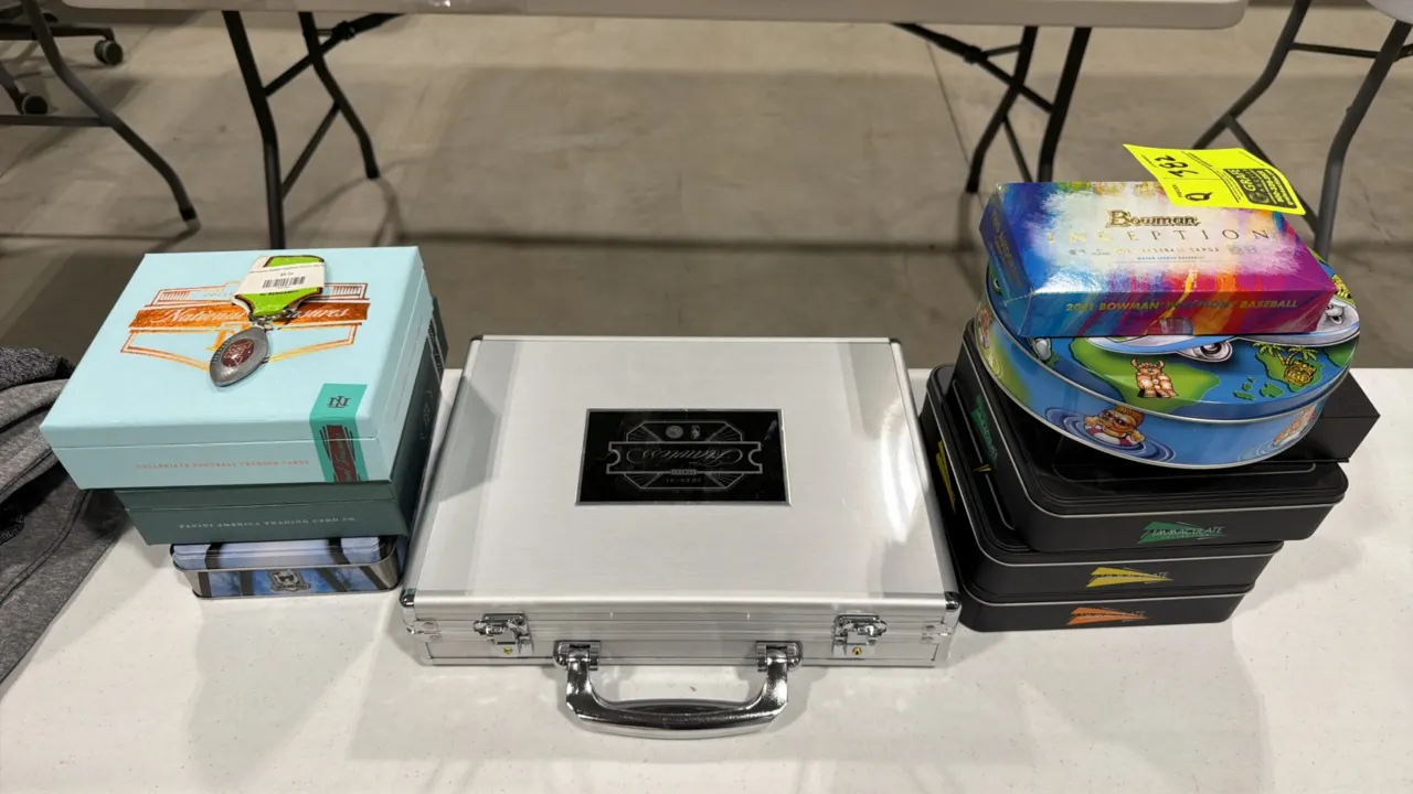 Assorted trading card storage boxes, tins, and briefcase lot. Includes Panini Flawless NBA aluminum briefcase with keys and foam insert, Panini Nation