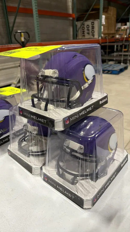 A Collection of Riddell Minnesota Vikings Mini Helmets and Commemorative Cloth. (Riddell/NFL) Features Minnesota Vikings team colors, horn decals, and