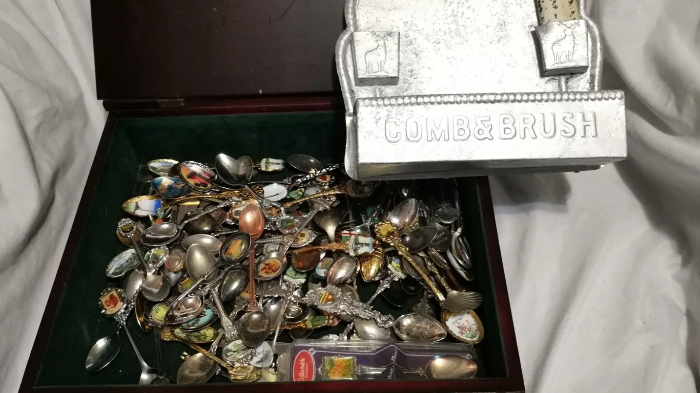 Collector spoon lot + tin antique comb brush holder