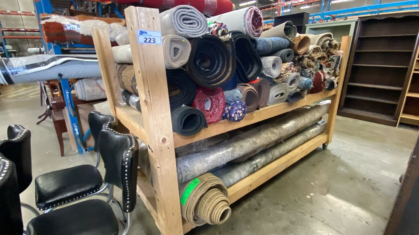 WOODEN MOBILE SHELF UNIT LOADED WITH ASSORTED AREA RUGS & RUNNERS - APPROX. 65 ASSORTED