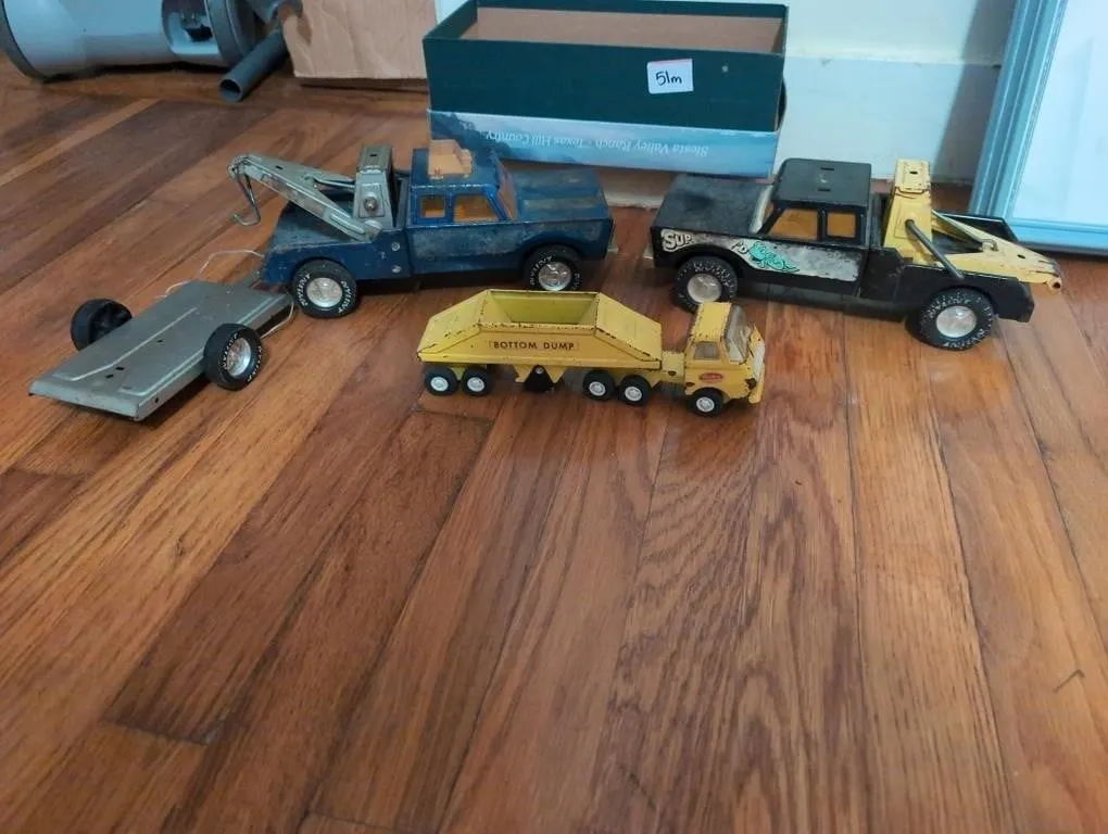 Vintage metal tow trucks, trailer, and small