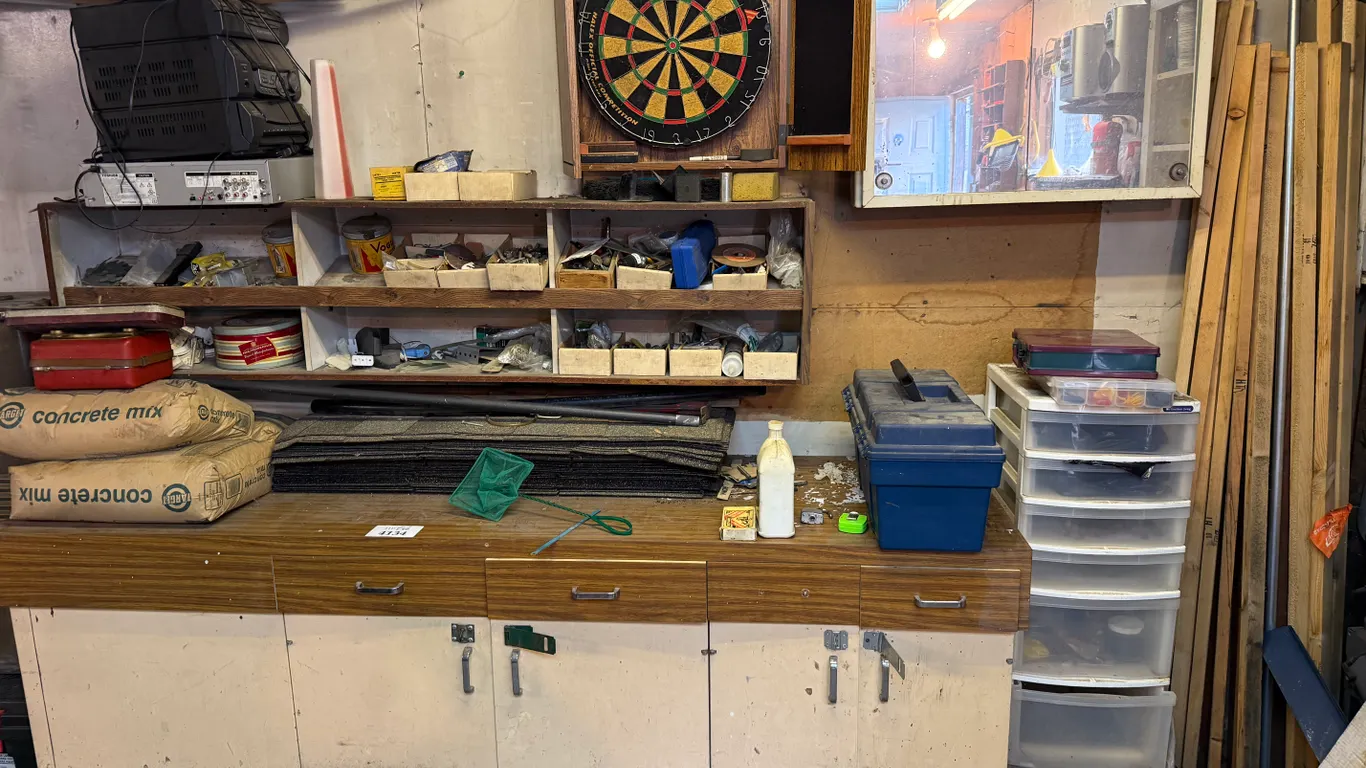 All Counter Top and Wall Contents Including Dart Board, Cement Bags, Shingles, Fasteners, Tools and