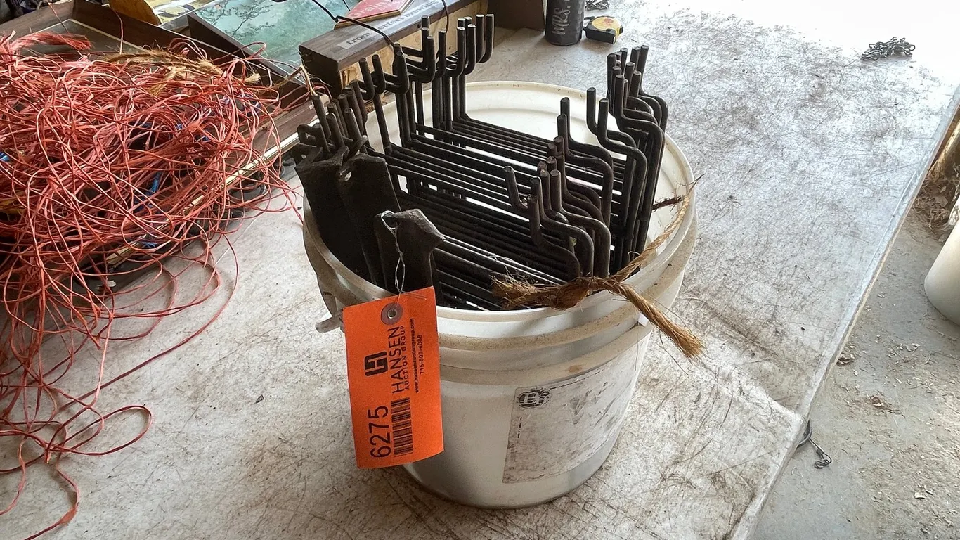 Pail of Conibear Trap Stakes