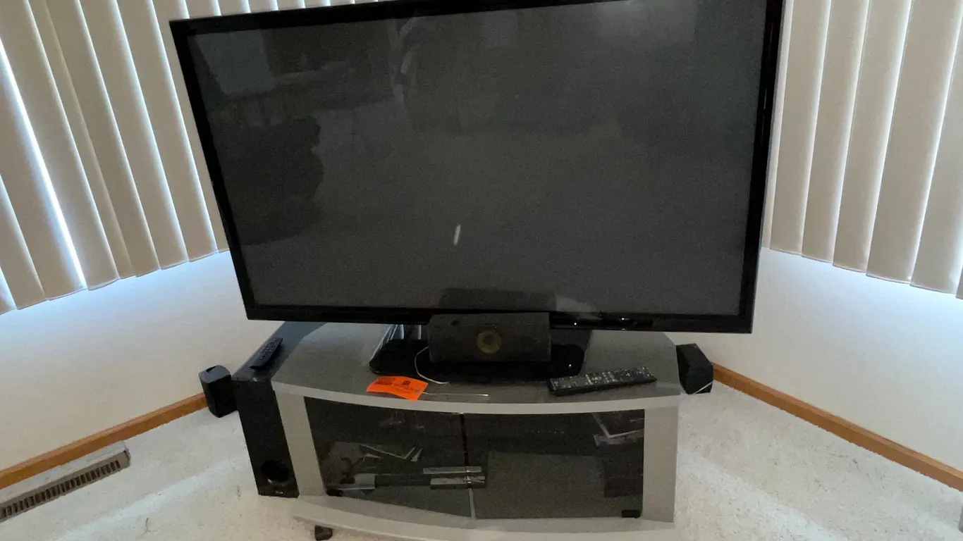 LG 50" TV, Surround Sound System, End Table, and Recliner