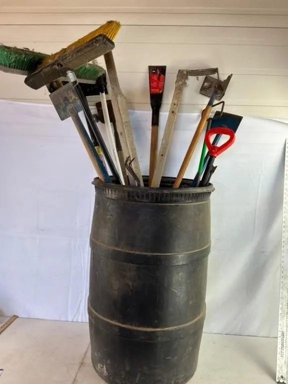 Mixed Garden Tools in Plastic Barrel