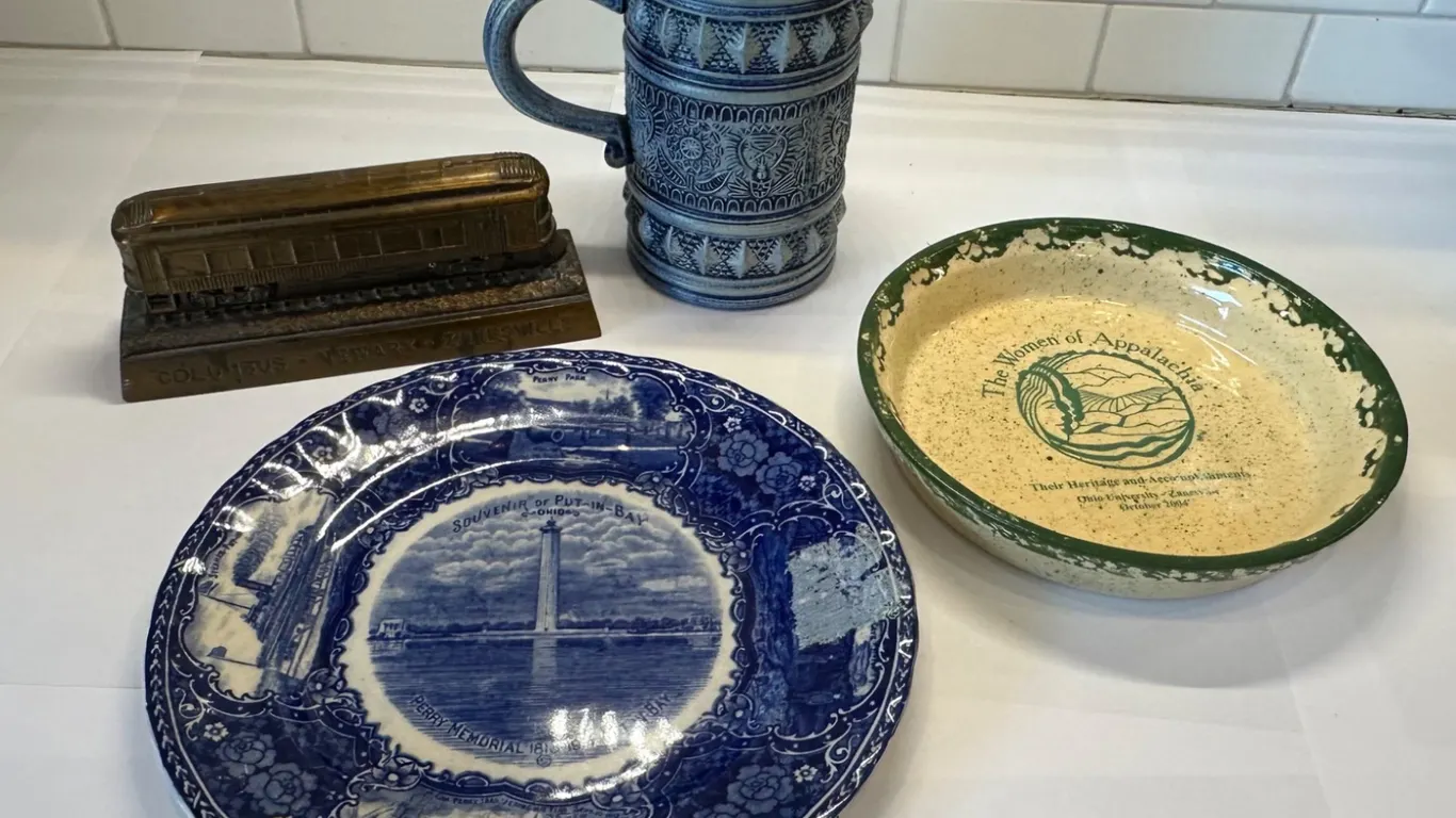 Plates, Mug, and Metal Railway Bank Featuring Historical Themes