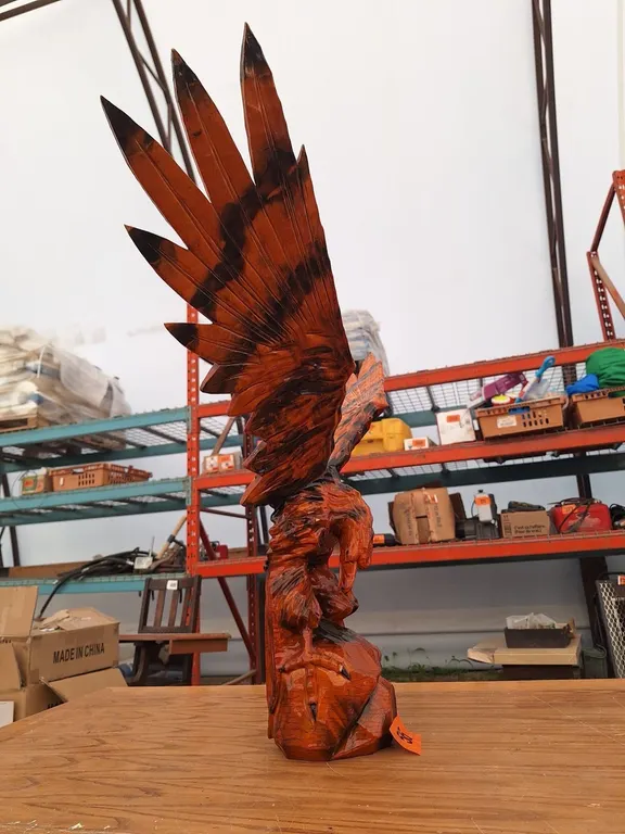 Chainsaw carved hawk. 30" H by 40" W