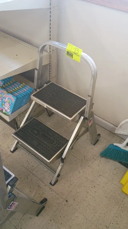 Little Jumbo 2-step folding step ladder. Features lightweight aluminum construction, slip-resistant textured step treads, folding frame, and integrate