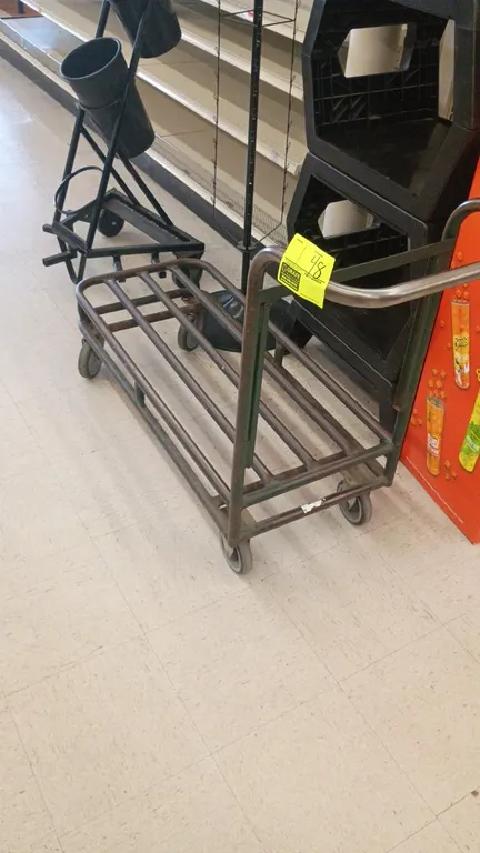 Stock cart. Features tubular steel construction and an integrated push handle. 41"L x 18"W. Mounted on casters.
