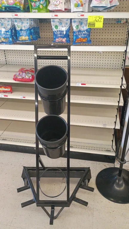 Metal clip merchandise display rack and floral display stand. Includes (1) rotating hanging clip strip spinner display on a round pedestal base and (1