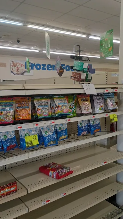 Assorted candy and snack inventory from a 12' section. Includes packaged candies, confections, beef jerky, and liquid drink enhancers. Shelving unit n