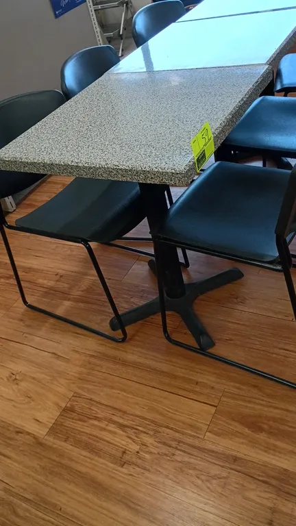 2-person dining tables with chairs. Features speckled laminate square tabletops on black metal pedestal X-bases. Includes black polypropylene and meta