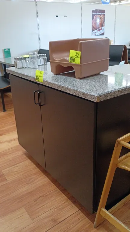 Service counter with 2-door storage cabinet. Features a speckled laminate countertop and black laminate base with wire pulls. 48"W x 29"D x 37"H. Cont