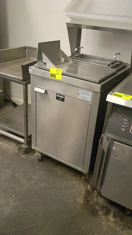 Giles stainless steel breading station. Features upper rack with plastic tub, prep area with perforated dip basket, and lower enclosed cabinet. 24" x