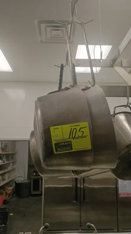 Aluminum sauce pots. Features commercial aluminum construction and riveted handles. Hanging rack and surrounding items not included.