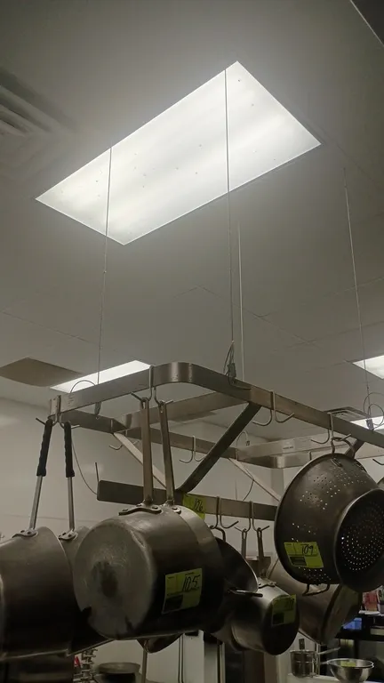 Stainless steel hanging pot rack. Features heavy-duty flat bar construction and pot hanging hooks. 48"L x 22"W. Ceiling suspended. Contents not includ