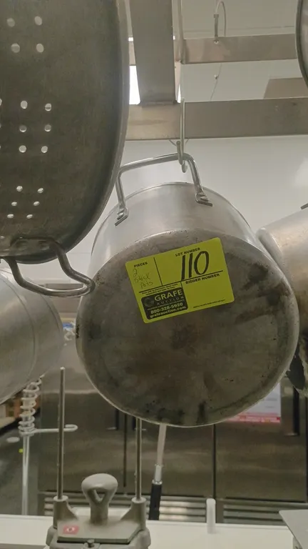 Aluminum stock pots. Features dual side handles. Note: Significant denting on pot base. Pot rack and hanging hooks not included.