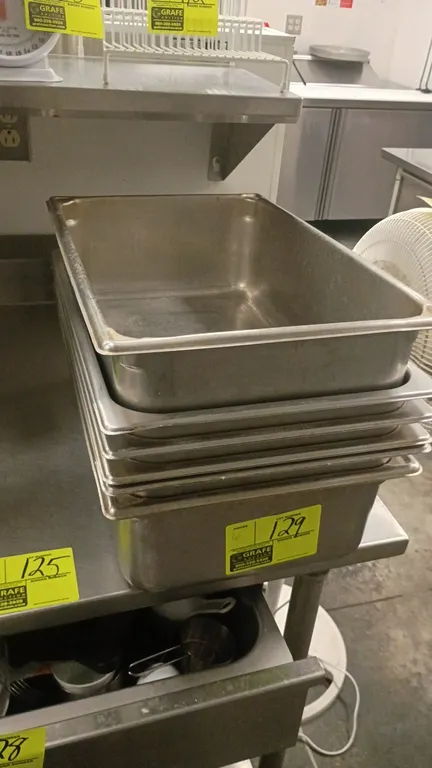 Stainless steel food pan inserts. Features stainless steel construction with reinforced edges and stackable design.