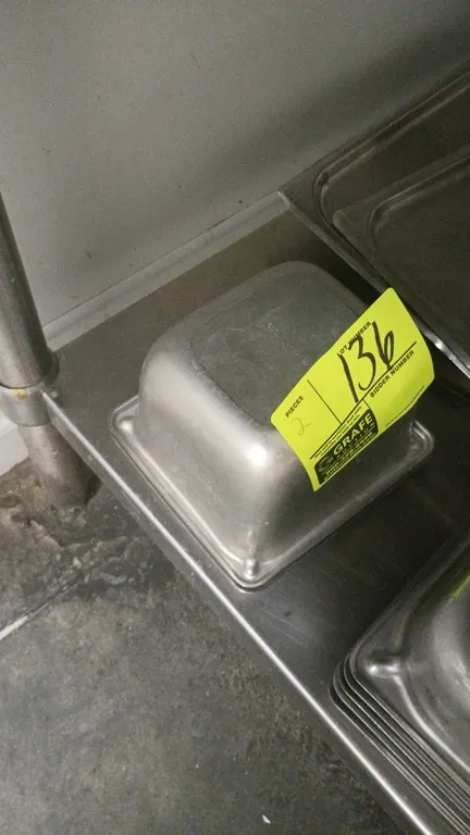Stainless steel insert pans. Includes (2) deep food pans. Table and surrounding items not included.