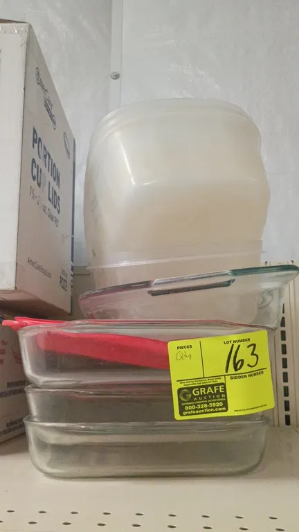 Assorted glass cake and baking pans. Includes rectangular glass baking dishes and nested plastic storage containers.