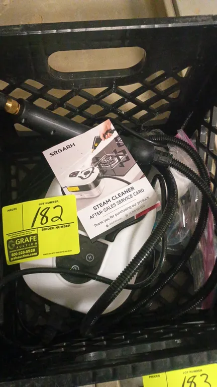 SRGARH portable steam cleaner. Includes flexible hose, spray wand attachment, and power cord. Milk crate not included.