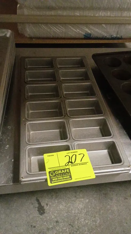 Mini loaf baking pans. Features 12 compartments per pan arranged in a 2x6 layout. Metal construction.