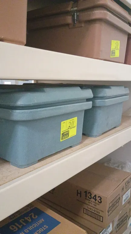 Cambro insulated food transport container. Features a top-loading design, secure metal latches, and molded handles. Polyethylene construction in slate