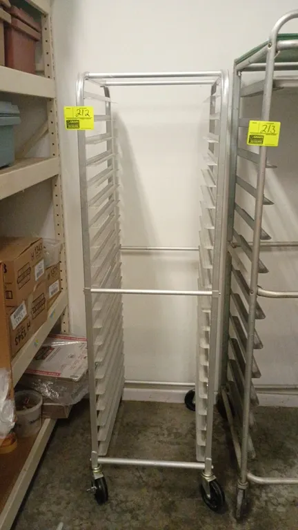 Aluminum rolling bakery cart. Features end-load sheet pan slides and lightweight aluminum frame construction. 20" x 26" x 69". Mounted on swivel caste