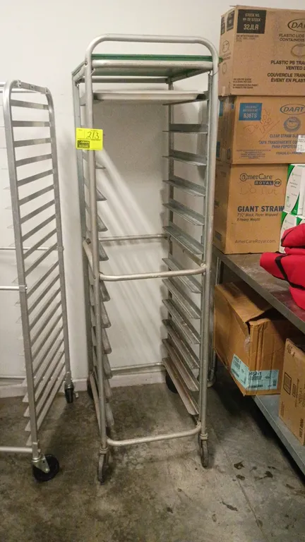 Metal rolling bakery sheet pan rack cart. Features multi-tier slide runners and a solid top shelf. 20" x 26" x 75". Mounted on casters.