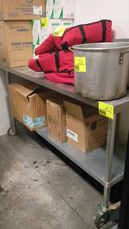 Stainless steel portable prep table. Features a lower undershelf. Dimensions: 72"L x 24"W x 41"H. Mounted on casters. Contents not included.