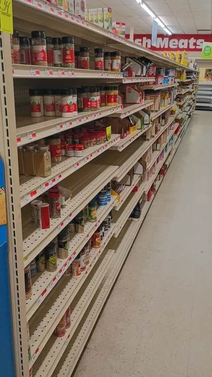 100'L of Lozier gondola shelving. Features 72"H uprights with 22"D base shelves on both sides and multi-tier adjustable upper shelving. Contents not i