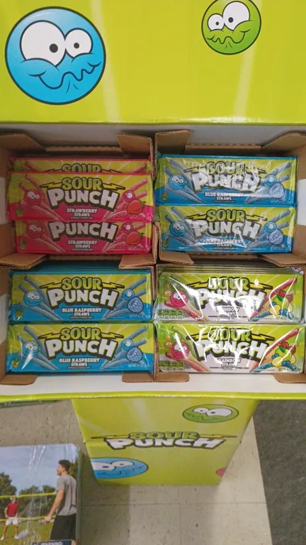 Sour Punch cardboard retail candy display. Includes assorted 4.5 oz Sour Punch Straws candy packs in Strawberry, Blue Raspberry, and Rainbow flavors.