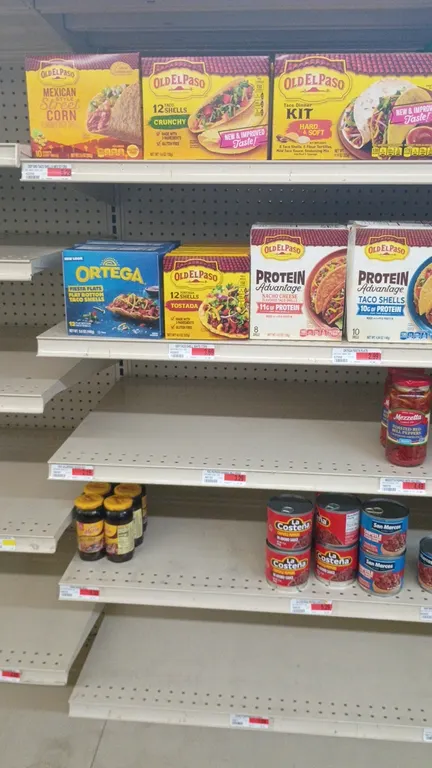 Assorted grocery shelf contents from a 4' section. Includes Old El Paso taco shells and dinner kits, Ortega and Charras tostadas, Valentina hot sauces