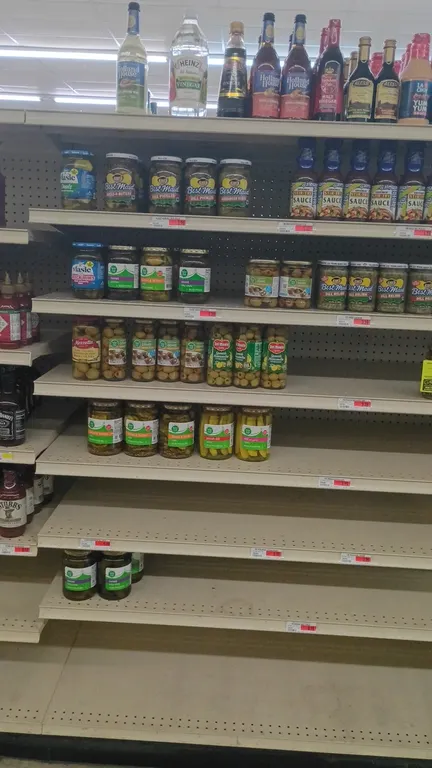 Assorted grocery inventory. Includes the contents of a 4' shelving section featuring olives, pickles, relish, cooking wine, vinegars, and specialty sa
