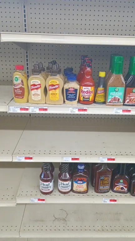 Contents of 4' shelving section. Includes assorted BBQ sauces, hot sauces, marinades, and condiments. Features brands including Kraft, Stubb's, Tabasc