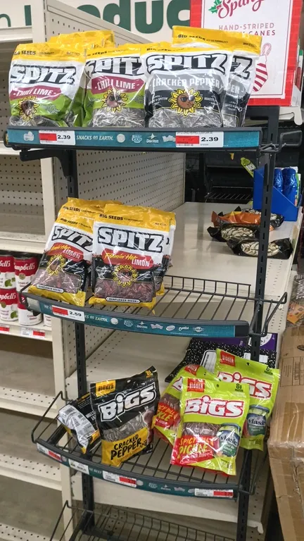 Contents of 4' shelving section. Includes pistachios, TopCare sunscreen, after-sun cooling gel, candy canes, sunflower seeds, notebooks, composition b