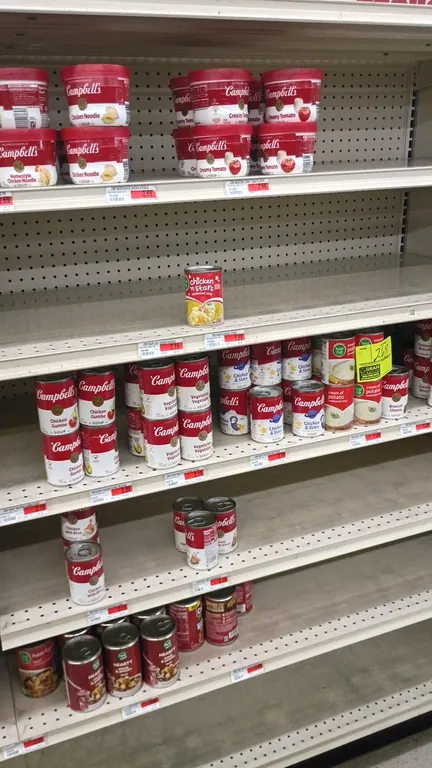 Assorted Campbell's and Food Club soup inventory. Includes various canned and microwavable soups from a 4' shelf section. Shelving not included.