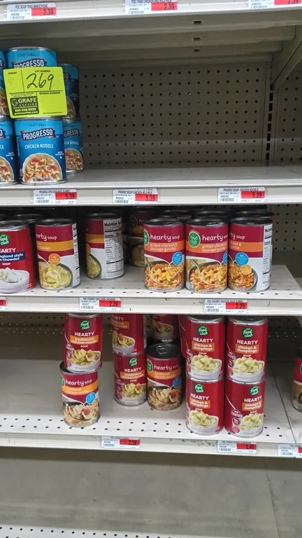 Contents of 4' section of assorted canned soups. Includes Progresso, Food Club, Campbell's Chunky, and Old El Paso varieties such as chicken noodle, v